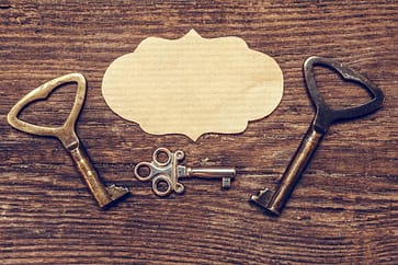 Old antique key and a set of vintage keys on a wooden background a flat top view, a concept of
